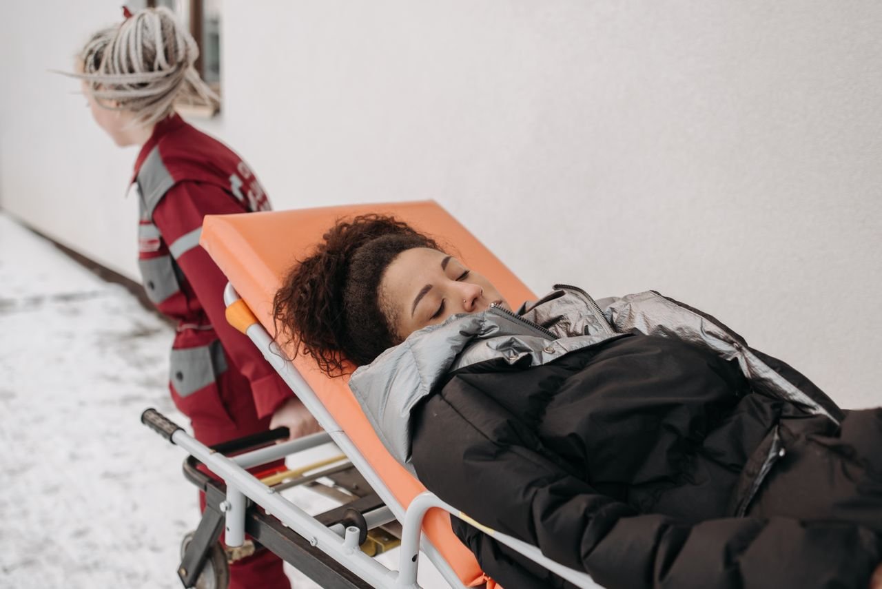 The Art of Drawing Readers In: Your attractive post title goes here Medical personnel assisting a patient on a stretcher outdoors in a snowy setting.